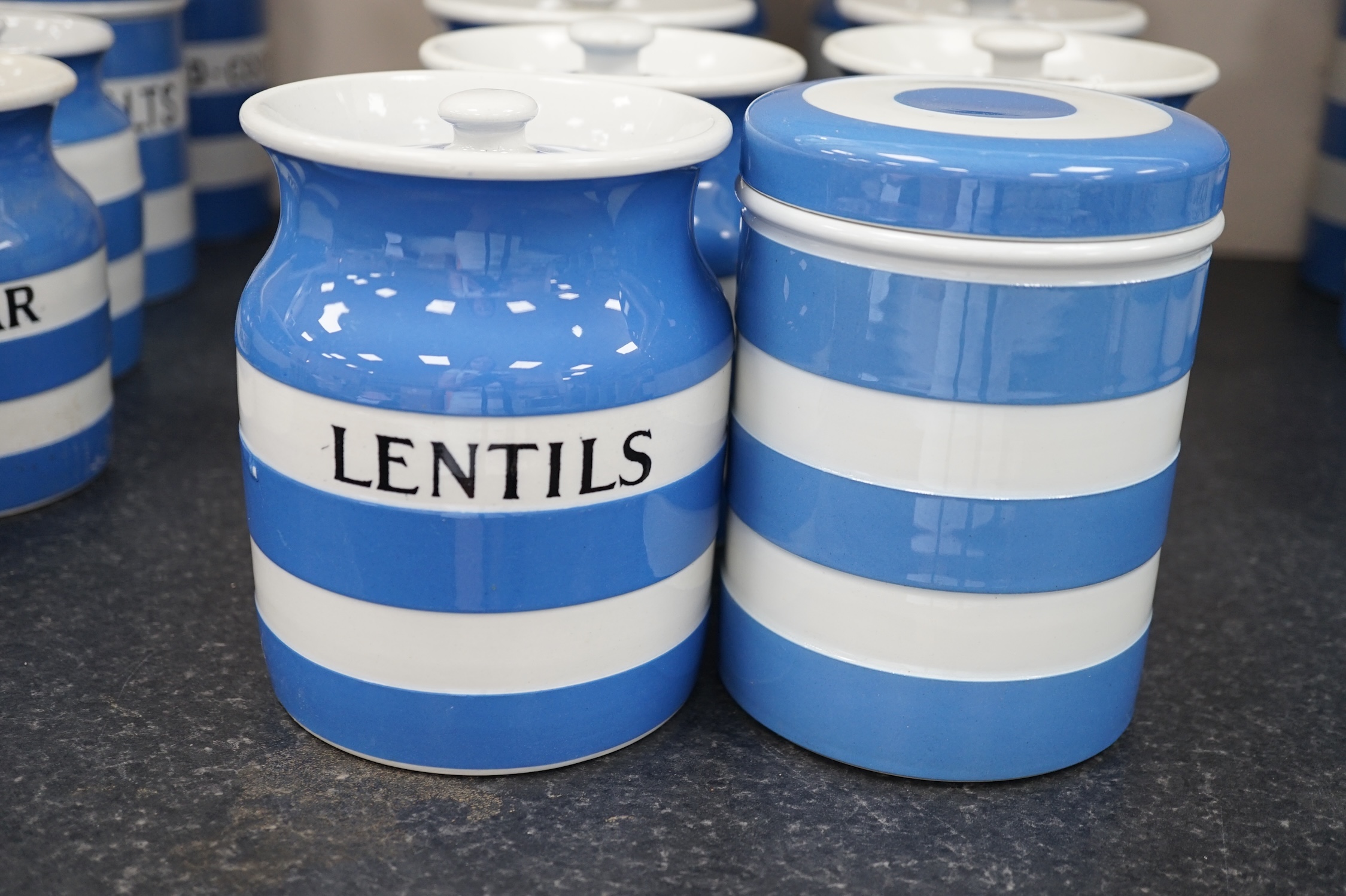 T.G.Green Cornish Kitchenware, eight lidded storage jars comprising Washing-Soda, Soda, Starch, Haricot Beans, Quaker Oats, Oatmeal, Lentils and one unnamed, largest 18cm high, mainly Black Shield marks. Condition - fair